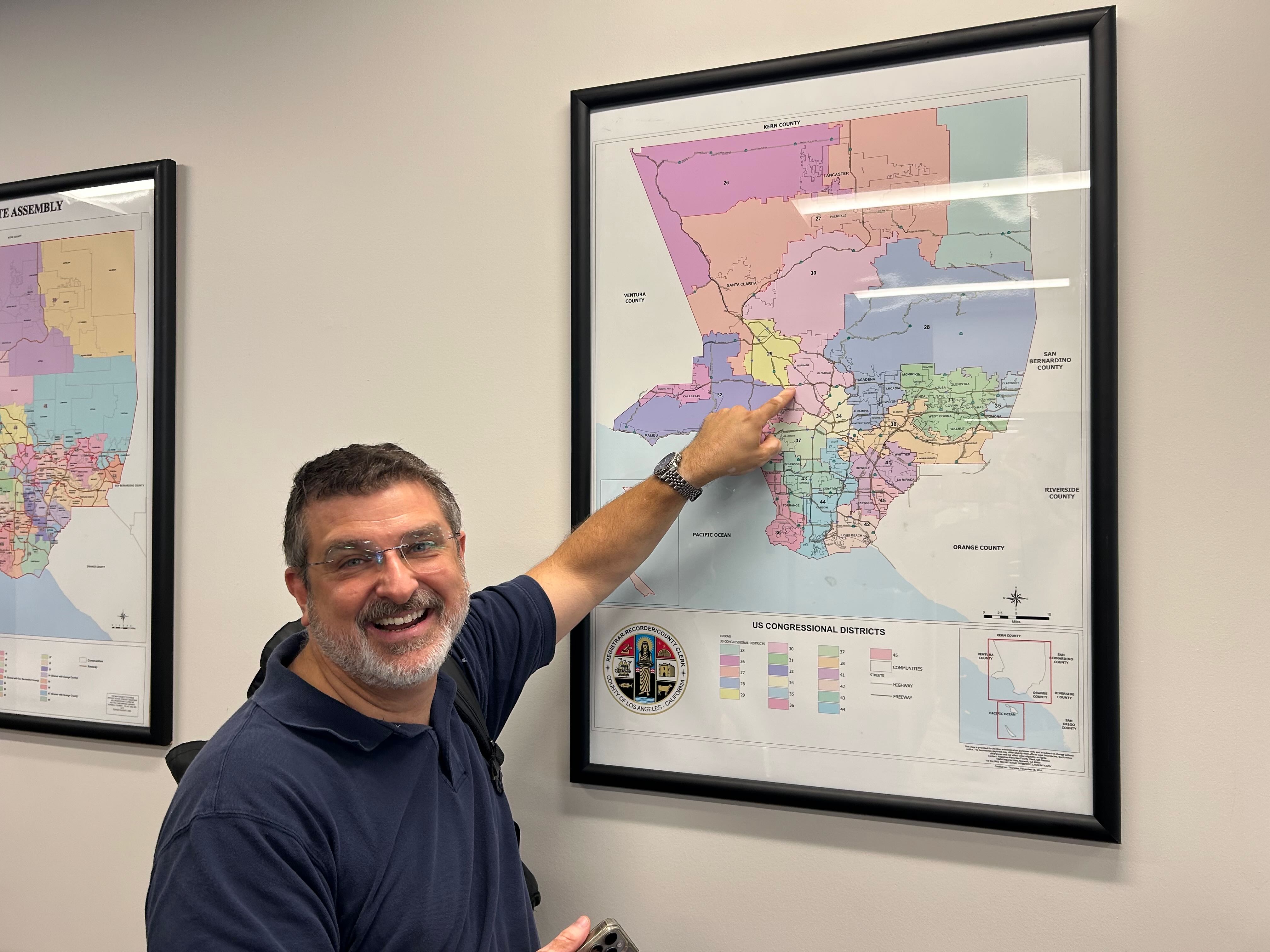 Paul pointing at a congressional districts map
